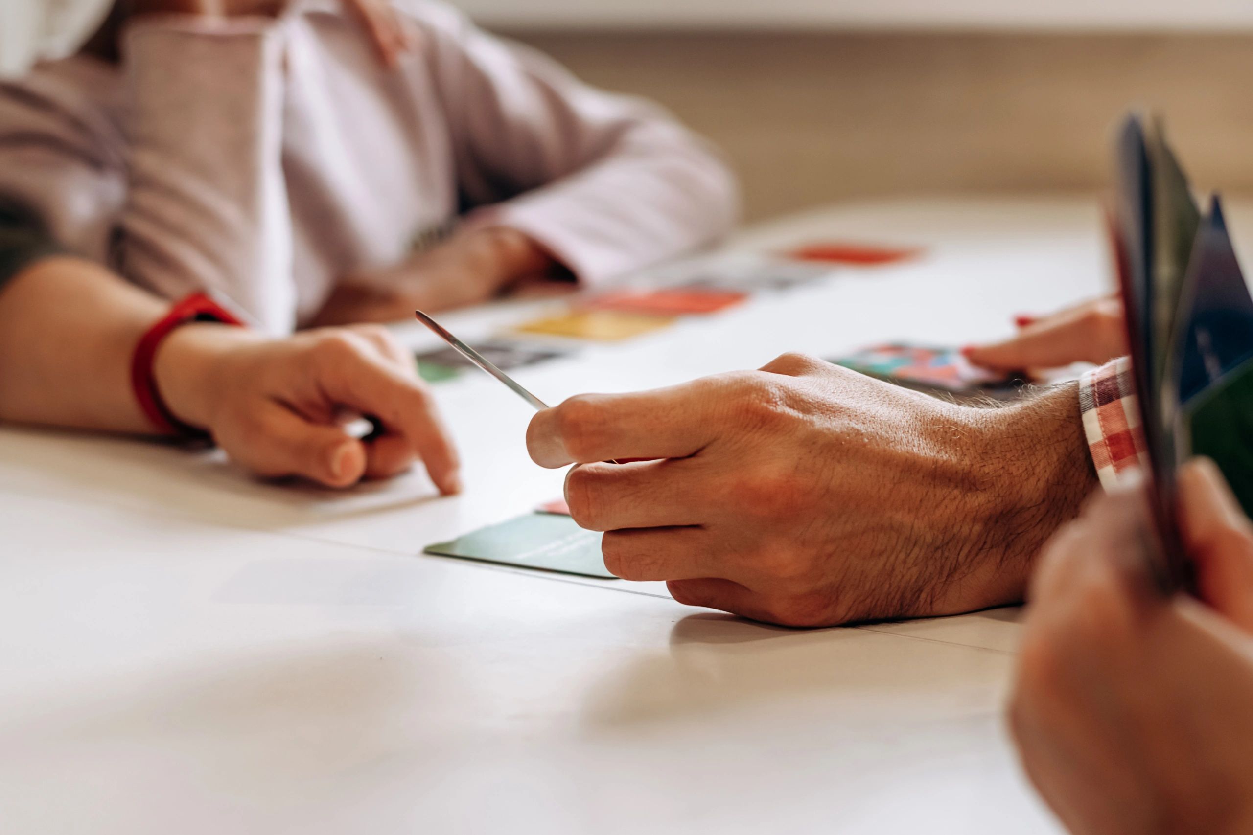 Close-up of hands playing a tabletop game