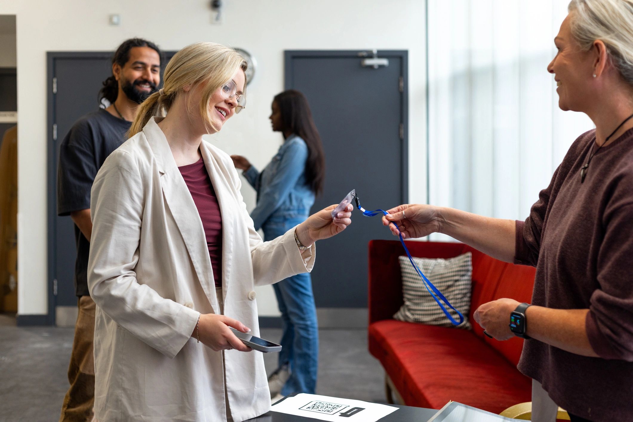 People checking in at an event registration desk