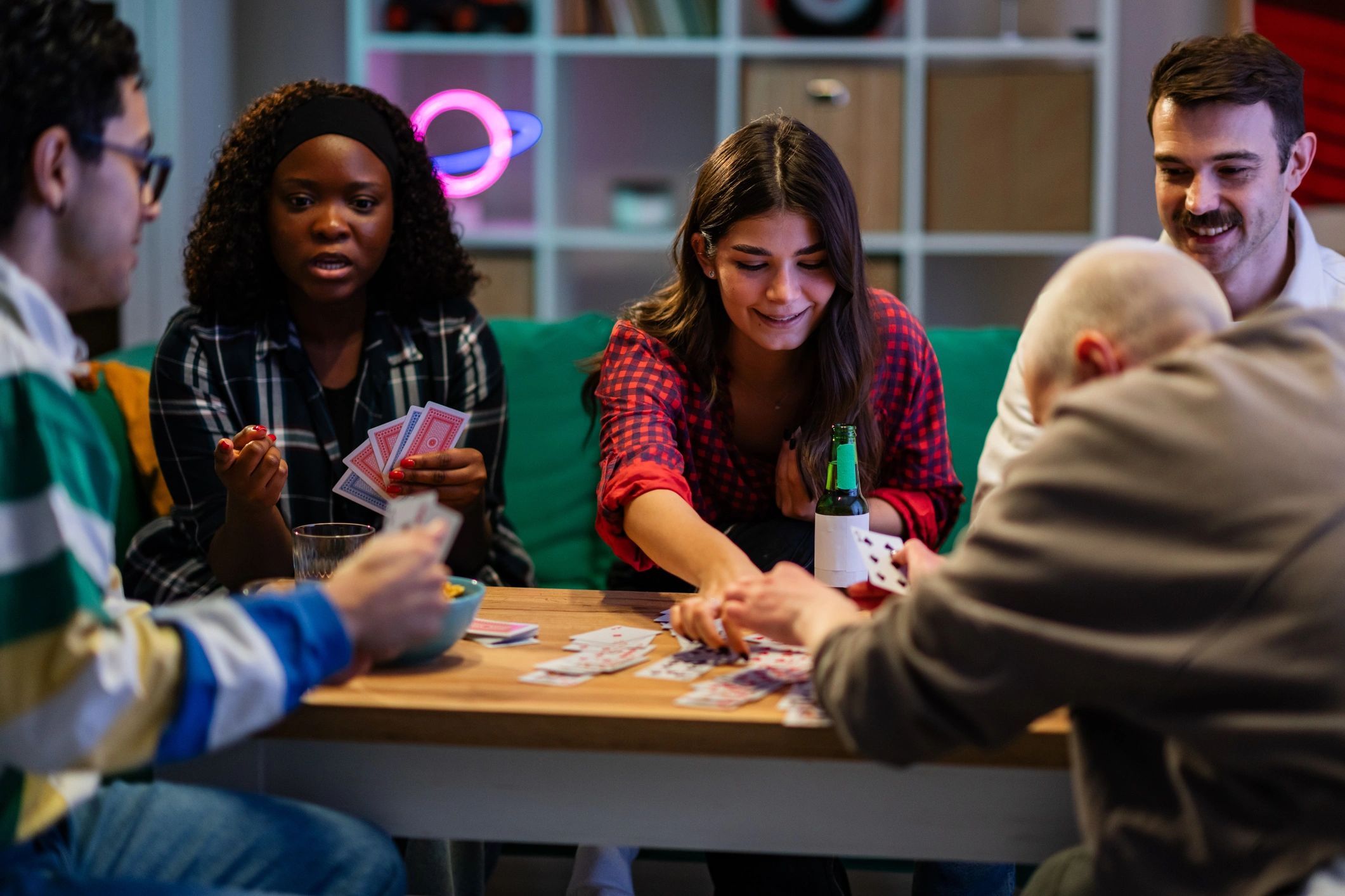 Friends playing cards together at a casual meetup